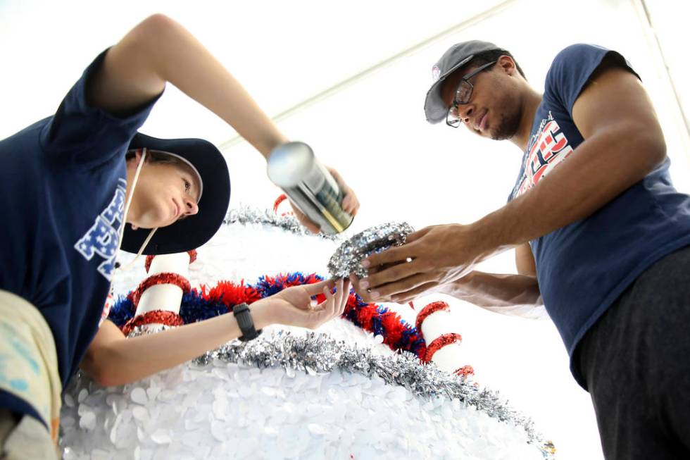 Connor Jordan, left, and Dwight Jones work in the Happy Birthday America float during a media p ...