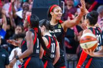Las Vegas Aces center A'ja Wilson (22) celebrates a win with teammates after their overtime vic ...