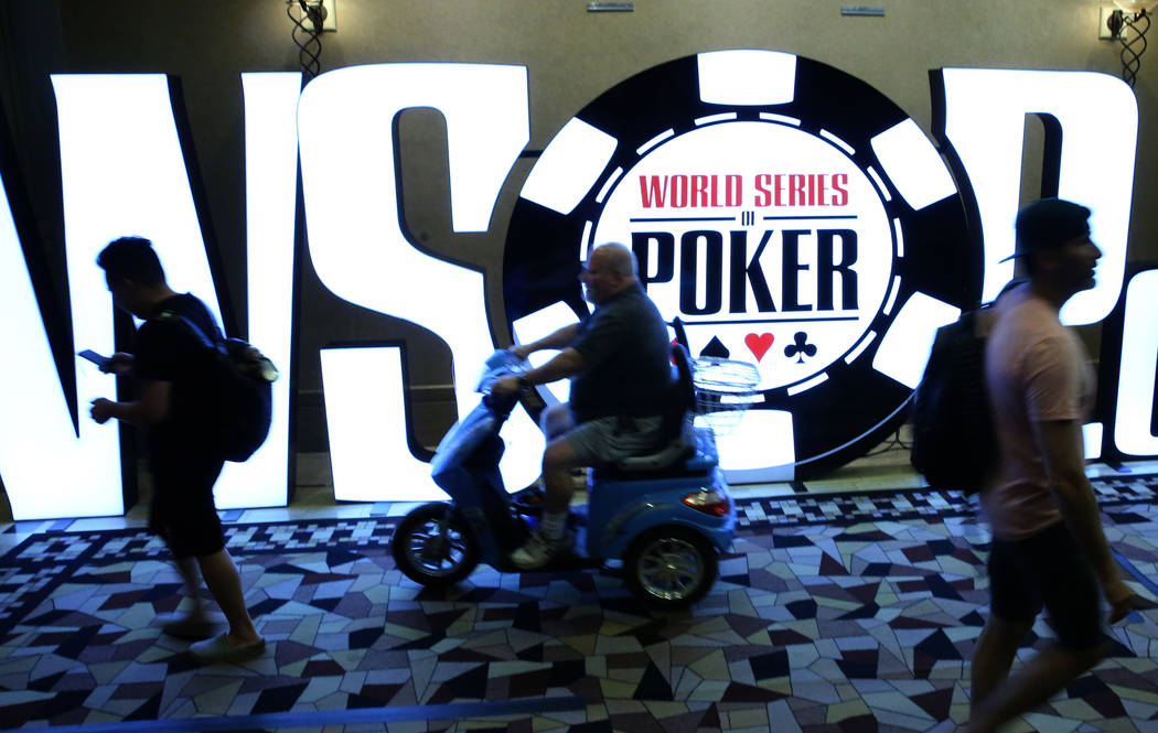 Players walk past the World Series of Poker Tournament (WSOP) sign during the 2019 WSOP tournam ...