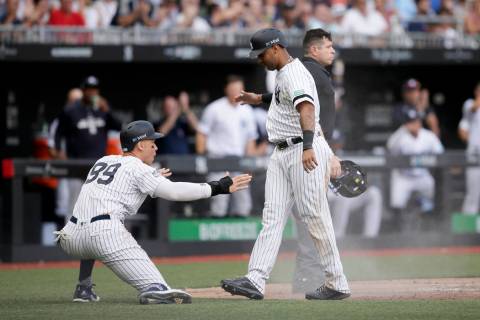 New York Yankees' Aaron Judge, left, and Aaron Hicks celebrate after scoring on a single by Gar ...