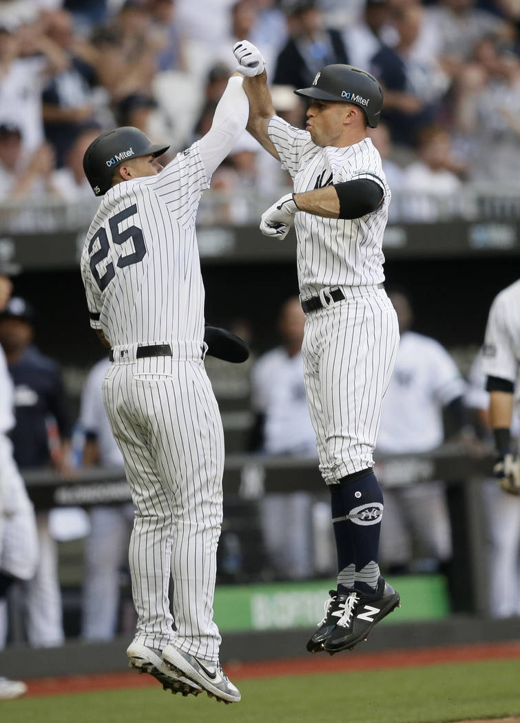 New York Yankees' Brett Gardner, right, celebrates after hitting a two-run home run with Gleybe ...