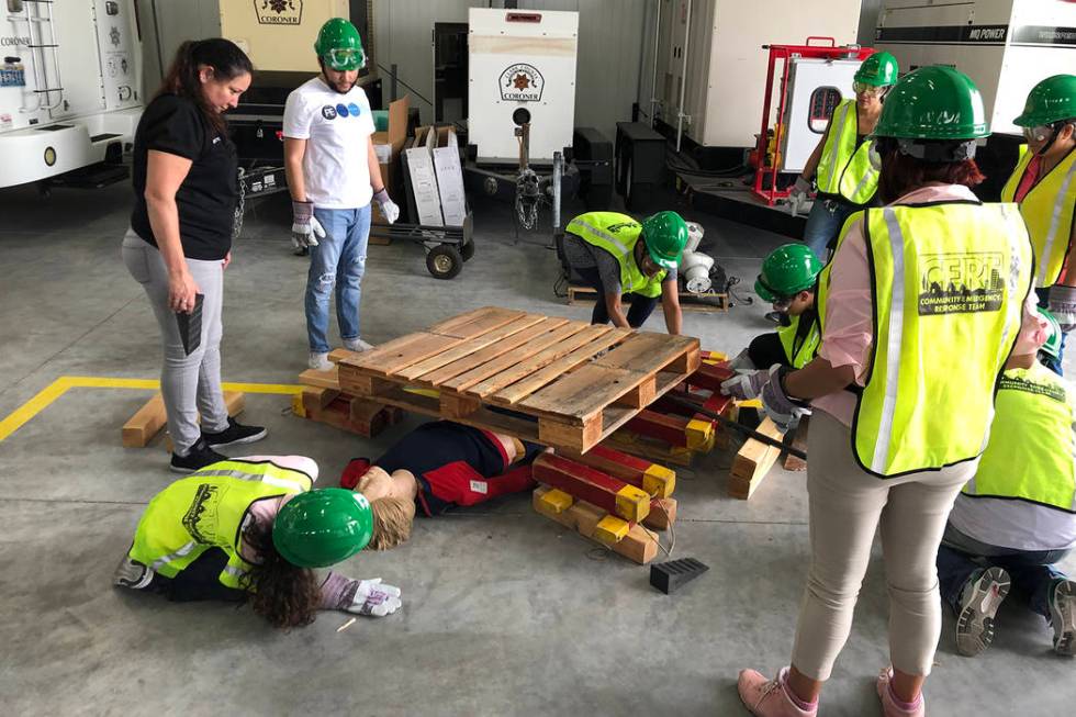 Zuzzette Bricker, left, instructs attendees of the CERT training course how to assist someone s ...