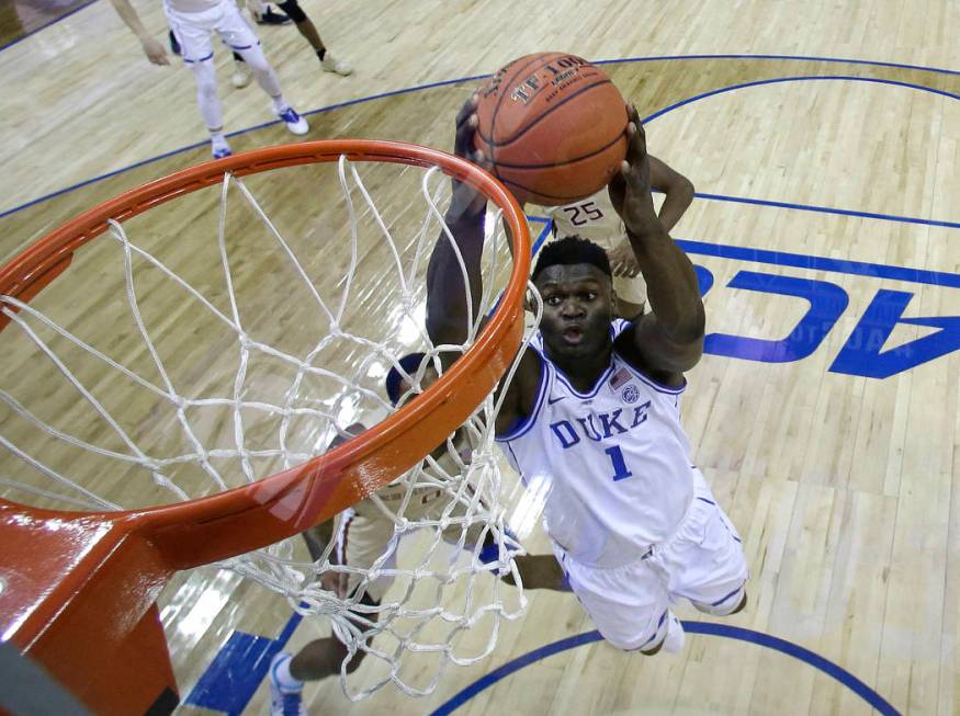 Duke's Zion Williamson (1) goes up to dunk against Florida State during the first half of the N ...