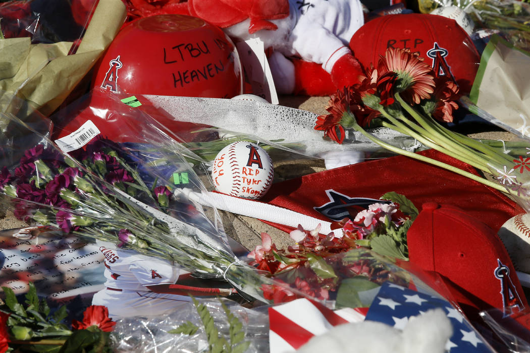 Los Angeles Angel fans place flowers, hats and mementos for pitcher Tyler Skaggs at Angel Stadi ...
