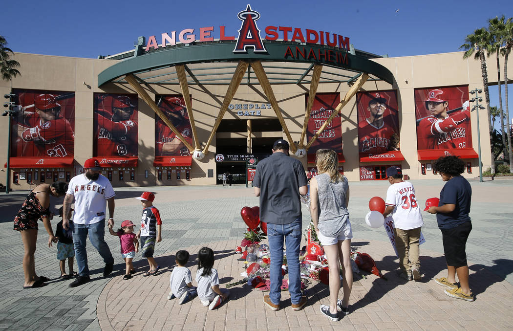 Mourners stand at a memorial to give their condolences for Los Angeles Angels pitcher Tyler Ska ...