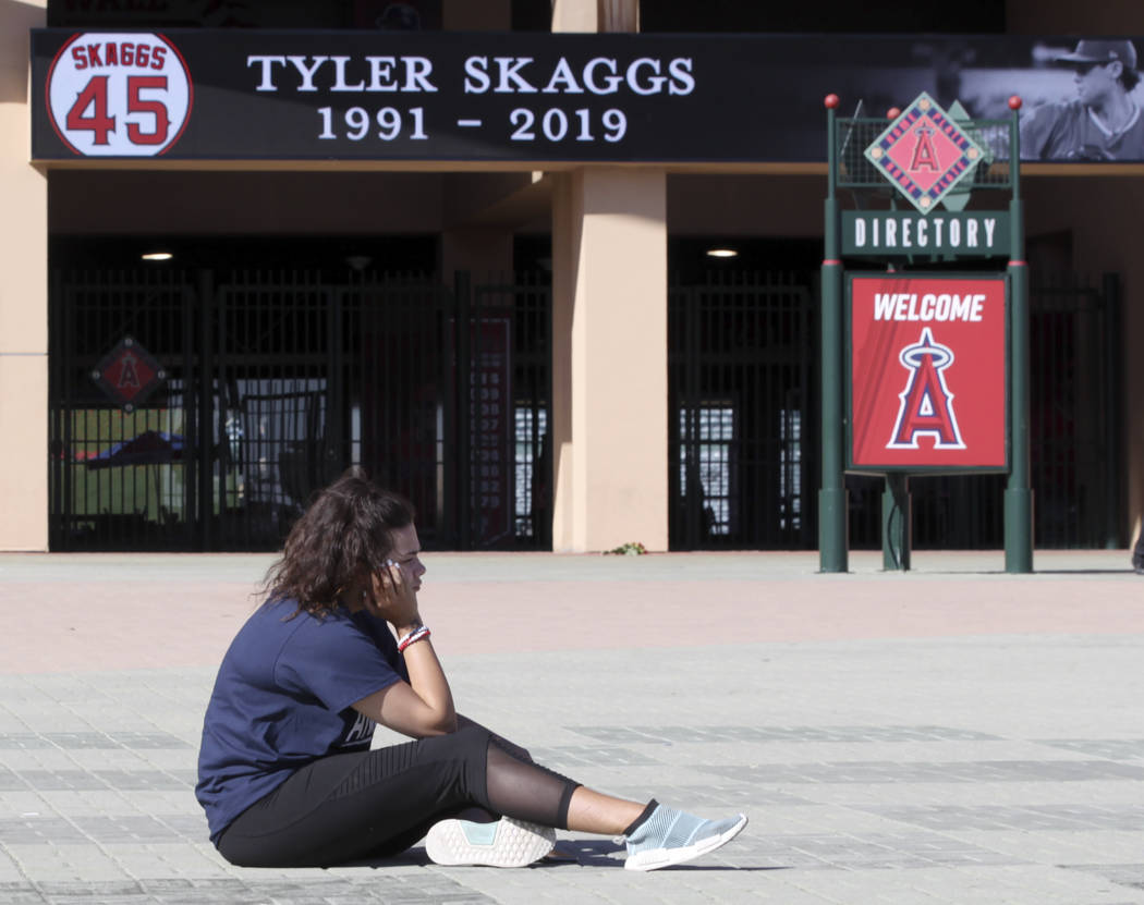 Los Angeles Angels fan Brieanna Gray mourns the loss of pitcher Tyler Skaggs at Angel Stadium i ...