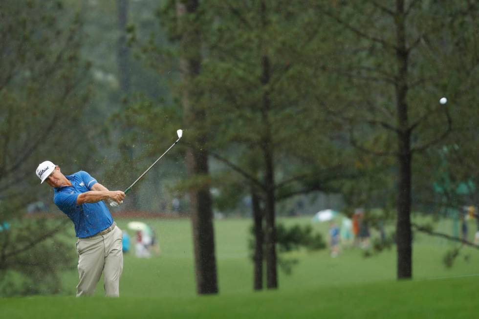 Charley Hoffman hits from the fairway in the rain on the first hole during a practice round for ...