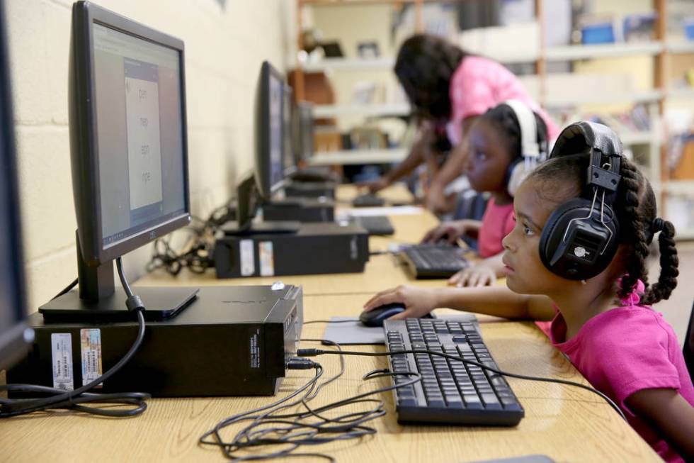 Kindergarten students Sorayah Battle, right, and Mackenzie Blockson to take a test in the libra ...