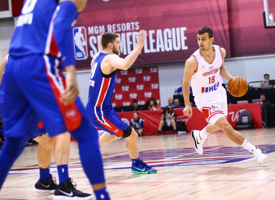 Croatia's Roko Badzim (18) moves the ball past Detroit Pistons' Sviatoslav Mykhailiuk during th ...