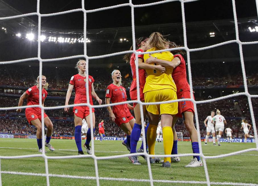 Team mates hug United States goalkeeper Alyssa Naeher after she saved a penalty shot taken by E ...