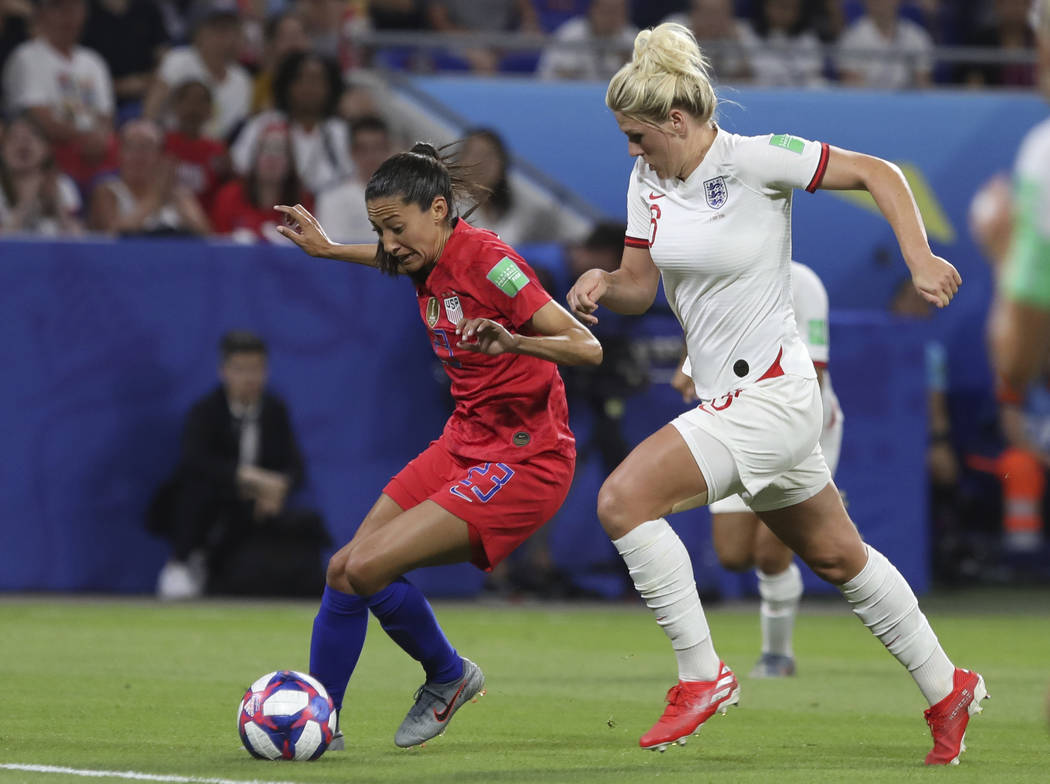 United States' Christen Press, left, and England's Millie Bright challenge for the ball during ...