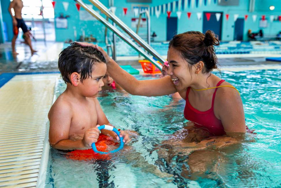 Swim instructor Shanneal Ocular talks with her student Louis Borado, 3, during a beginner swim ...