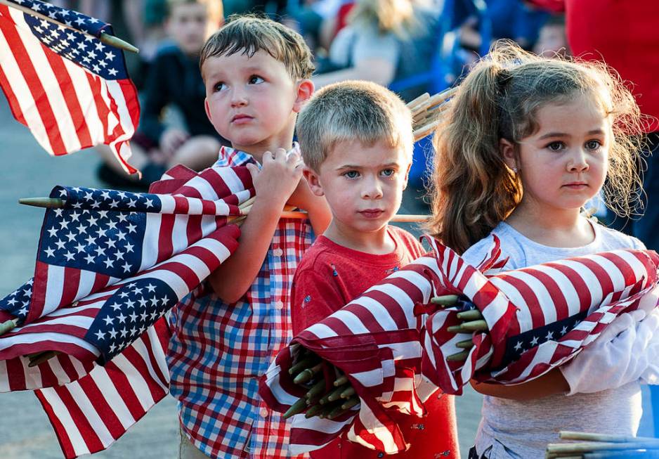 Brayden Austin, left, Gavin Colby, middle, and Brylee Roberge patiently wait with an armful of ...