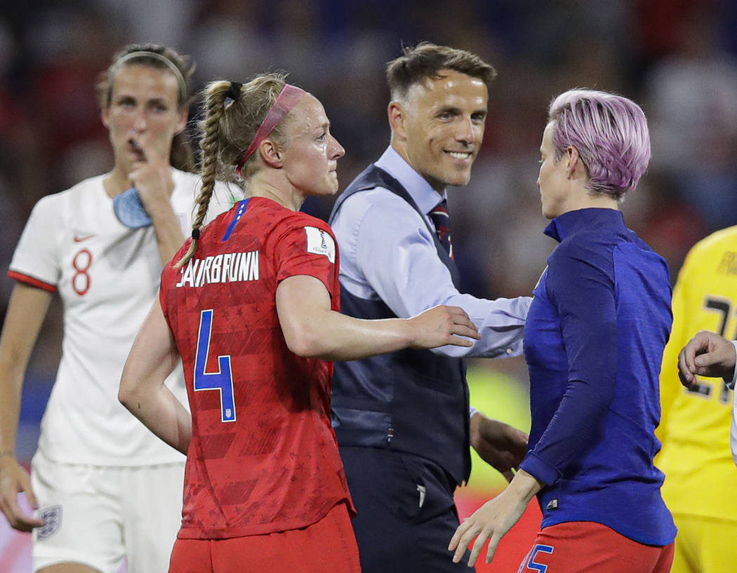 England head coach Philip Neville smiles to United States' Megan Rapinoe after the Women's Worl ...
