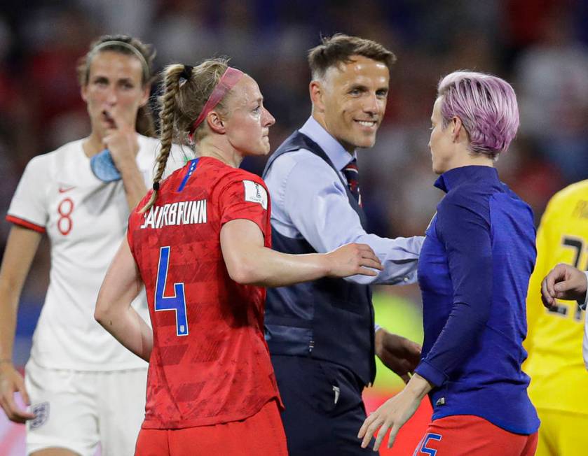 England head coach Philip Neville smiles to United States' Megan Rapinoe after the Women's Worl ...