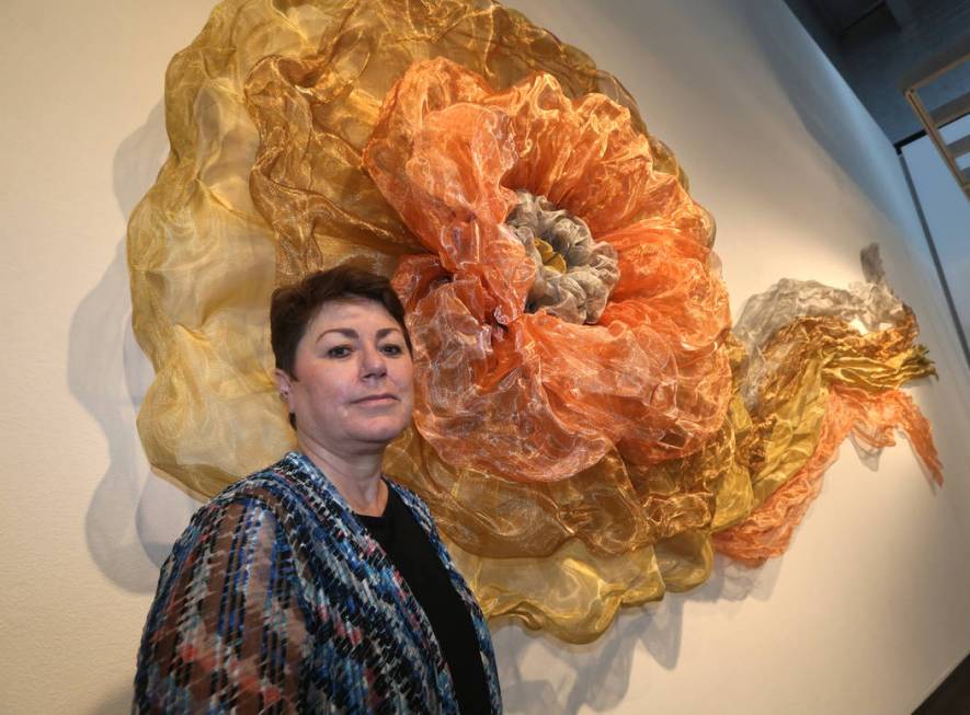 Denise Duarte in front of her sculpture entitled 'The Rosette' at Sahara West Library Art Galle ...