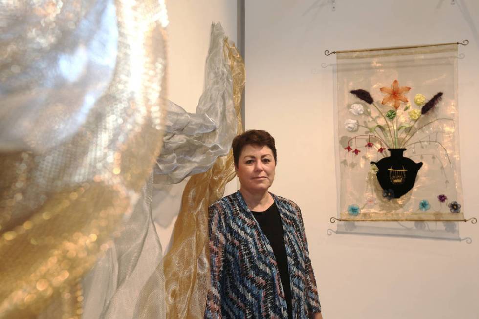 Denise Duarte in front of her sculptures "Unraveling Identity," left, and "Flora Varietas," at ...