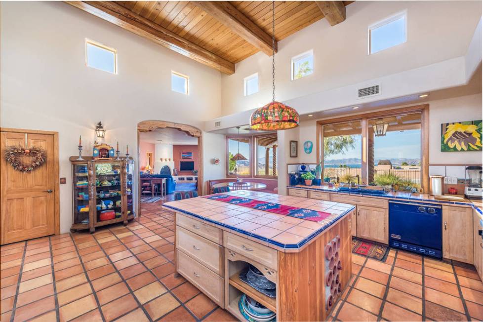 The colorful Southwestern kitchen features Saltillo tile flooring. (Desert Sun Realty)