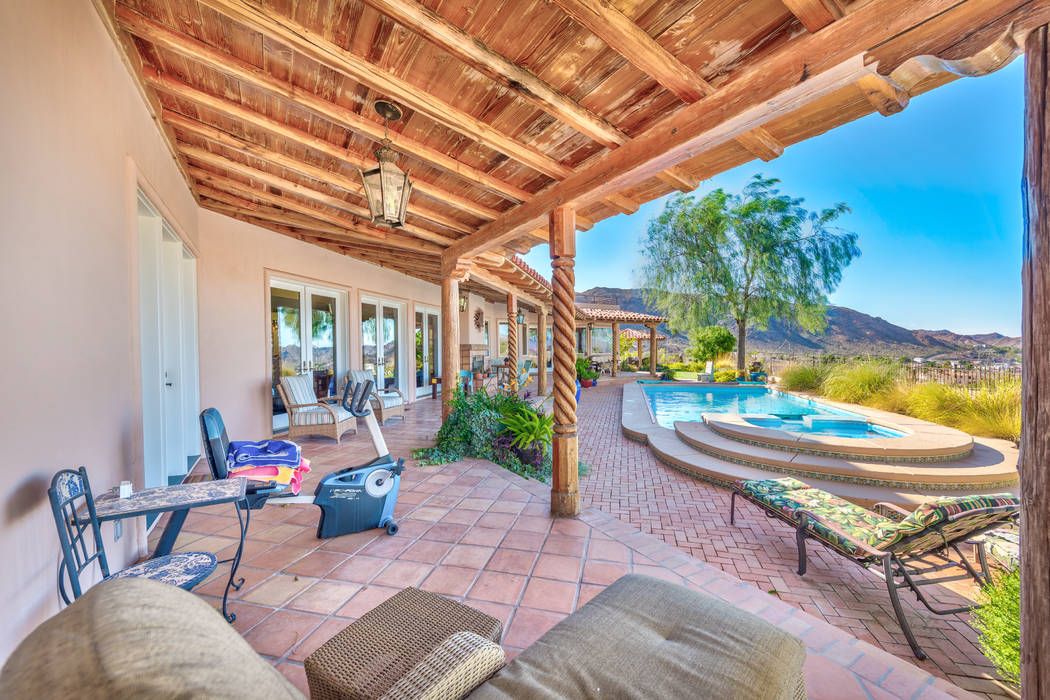 The home has a backyard patio and pool area. (Desert Sun Realty)