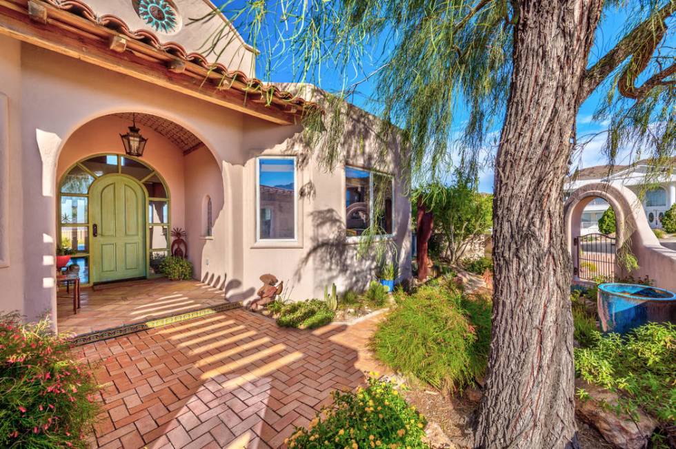 The entrance of the home features lush landscaping. (Desert Sun Realty)