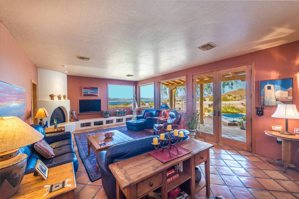 The living room features a kiva fireplace. (Desert Sun Realty)