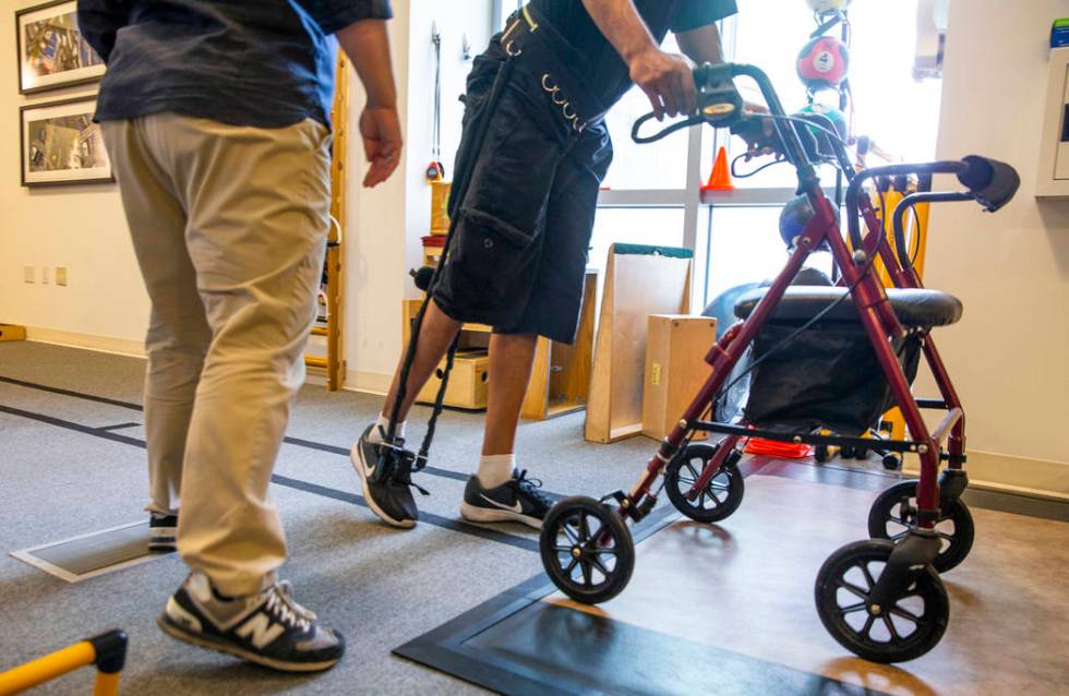 Physical Therapist Christine Ross works with a patient on a walking exercise within the therapy ...