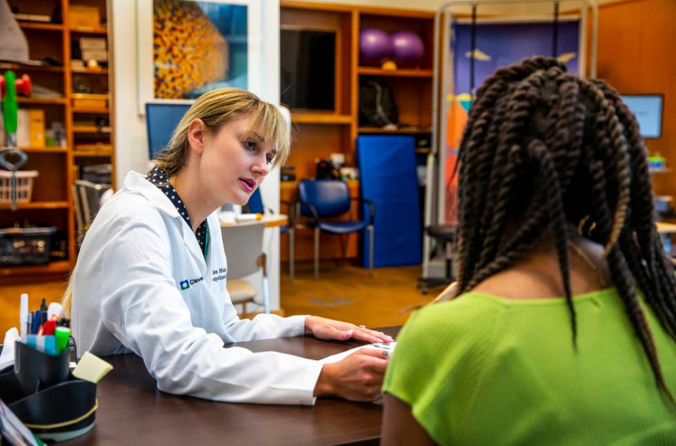 Occupational Therapist Madisen Mendez confers with a patient on the skills she would like to im ...