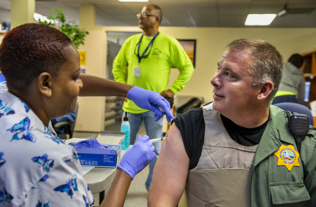 Tasheka Powell, Southern Nevada Health District registered nurse, gives Metropolitan Police Dep ...