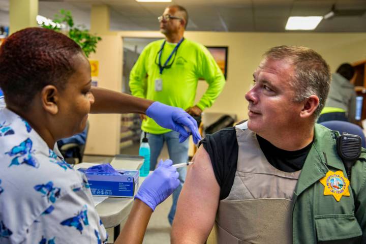 Tasheka Powell, Southern Nevada Health District registered nurse, gives Metropolitan Police Dep ...