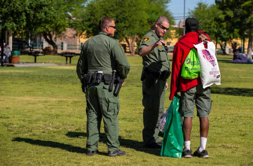 Metropolitan Police Department officers Keith Hanoff, left, and Kerry Reusch, center, make cont ...