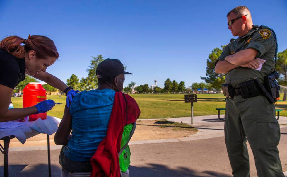 Sarah Lugo, Southern Nevada Health District senior community health nurse, gives a homeless man ...