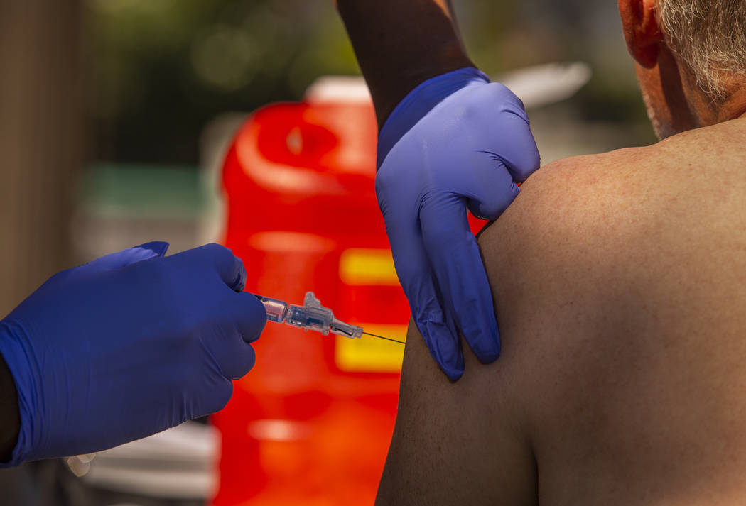 Tasheka Powell, Southern Nevada Health District registered nurse, gives a homeless man a Hepati ...