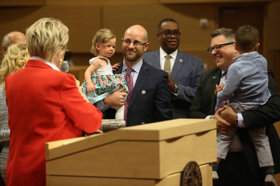 New Councilman Brian Knudsen, center, holding his daughter Kate, 1, with his husband Brian Eaga ...