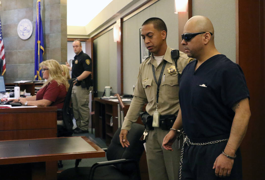 Gustavo Ramos-Martinez, who is accused of killing two elderly people in 1998, is led into the c ...