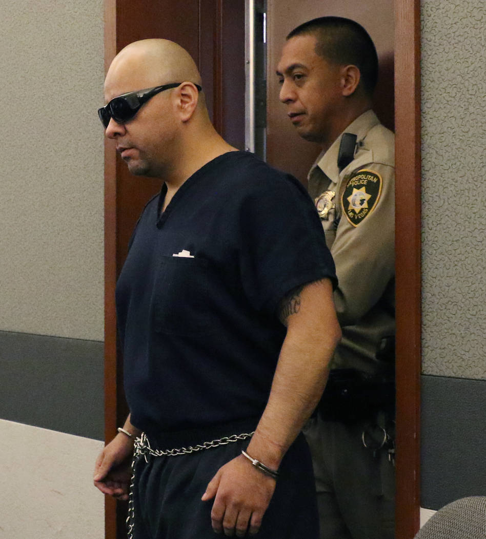 Gustavo Ramos-Martinez, who is accused of killing two elderly people in 1998, is led into the c ...