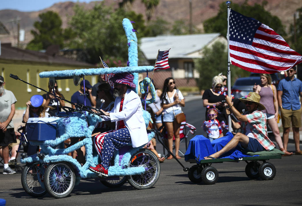 A furry surrey bicycle is driven by Burning Man enthusiasts during the parade at the annual Dam ...