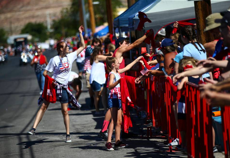 Wet towels are passed out by supports of Boulder Dam Credit Union during the parade at the annu ...