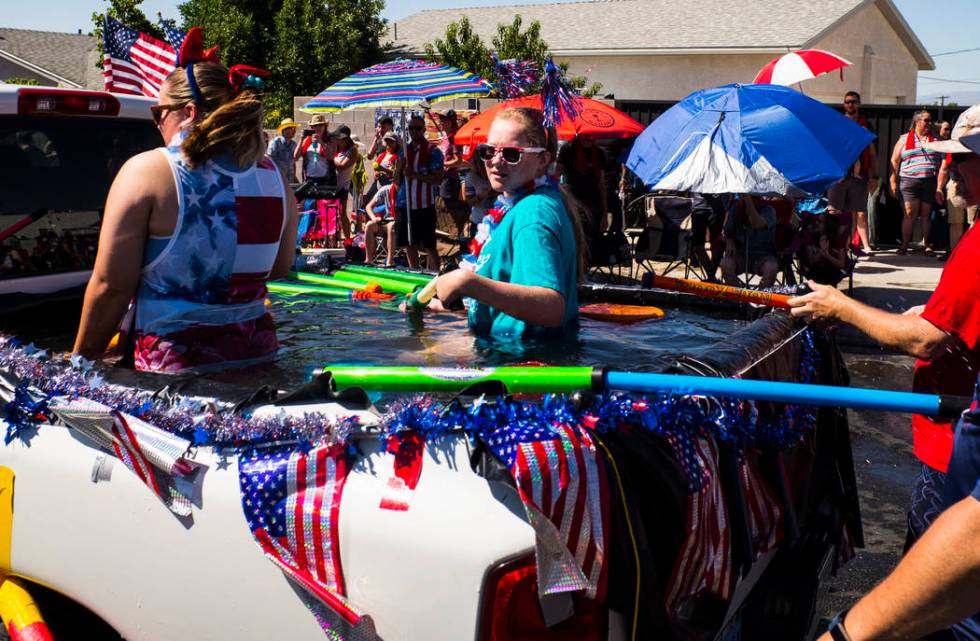 Parade participants prepare to partake in water fights during the parade at the annual Damboree ...