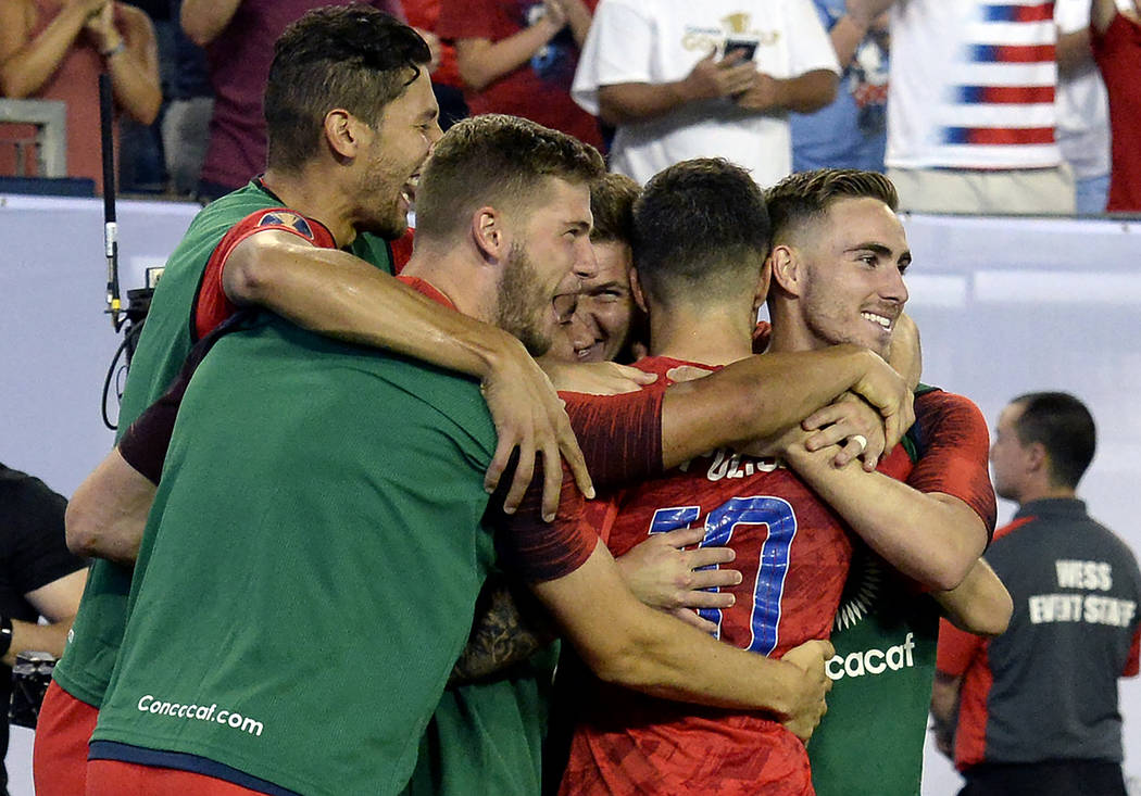 United States midfielder Christian Pulisic (10) celebrates with teammates after scoring a goal ...