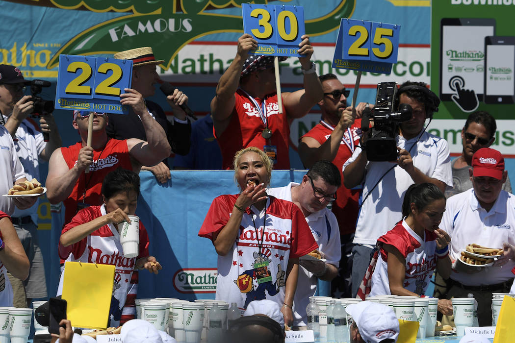 Juliet Lee, left, Miki Sudo, center, and Michelle Lesko, right, compete in the closing moments ...