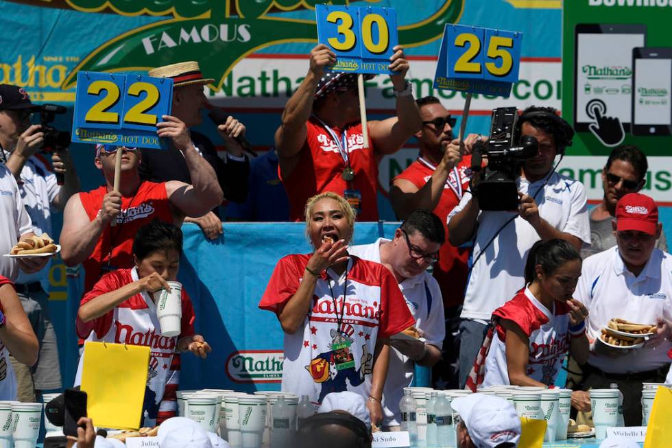 Juliet Lee, left, Miki Sudo, center, and Michelle Lesko, right, compete in the closing moments ...