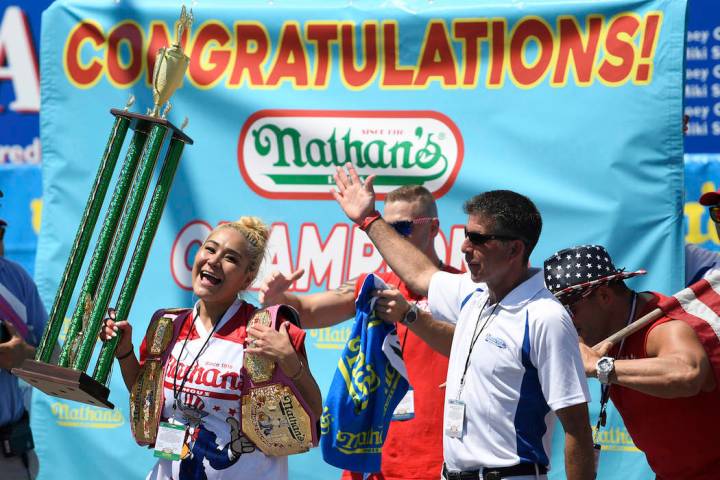 Miki Sudo reacts after receiving her trophy and belt for winning the women's competition of Nat ...