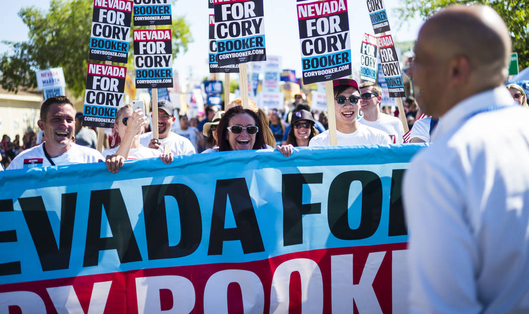 Supporters march in a parade with Democratic presidential candidate Sen. Cory Booker, D-N.J., d ...