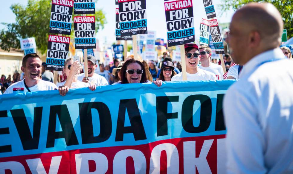 Supporters march in a parade with Democratic presidential candidate Sen. Cory Booker, D-N.J., d ...