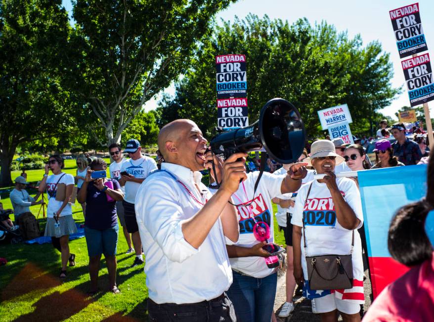 Democratic presidential candidate Sen. Cory Booker, D-N.J., uses a megaphone while talking with ...