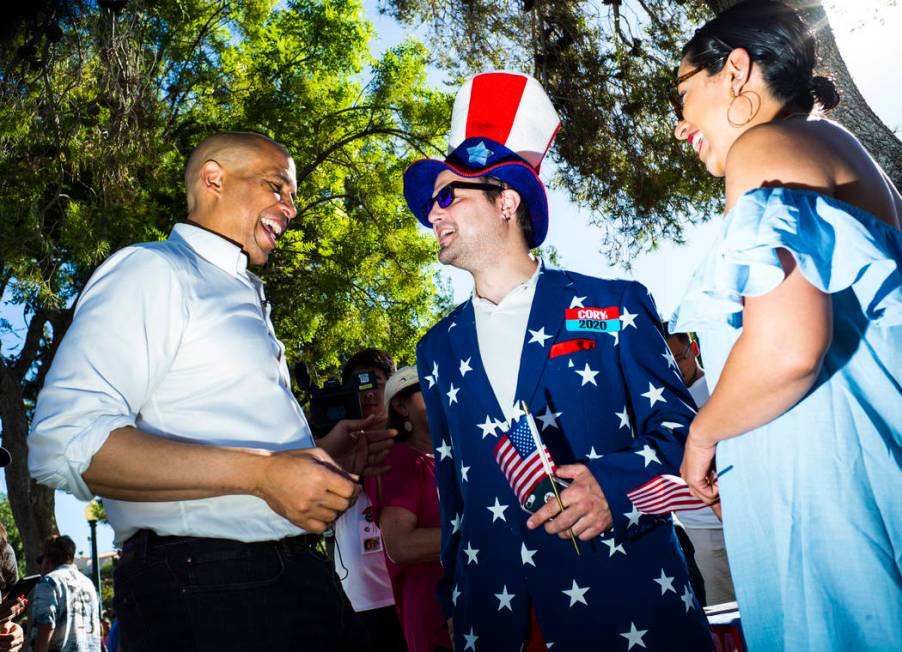 Democratic presidential candidate Sen. Cory Booker, D-N.J., left, talks with supporters Patrick ...