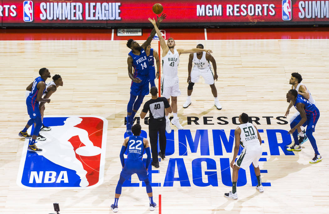 Philadelphia 76ers' Norvel Pelle (14) and Milwaukee Bucks' Jock Landale (43) jump for the ball ...