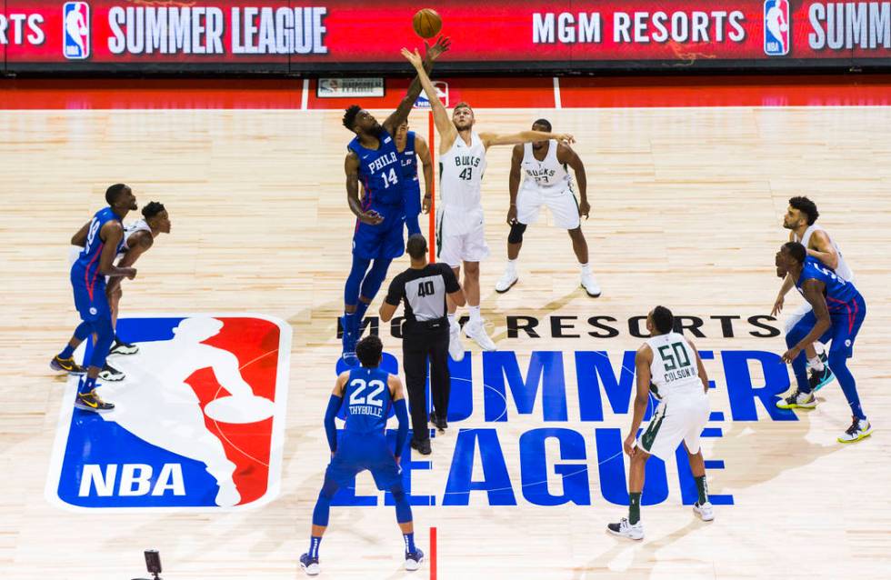 Philadelphia 76ers' Norvel Pelle (14) and Milwaukee Bucks' Jock Landale (43) jump for the ball ...