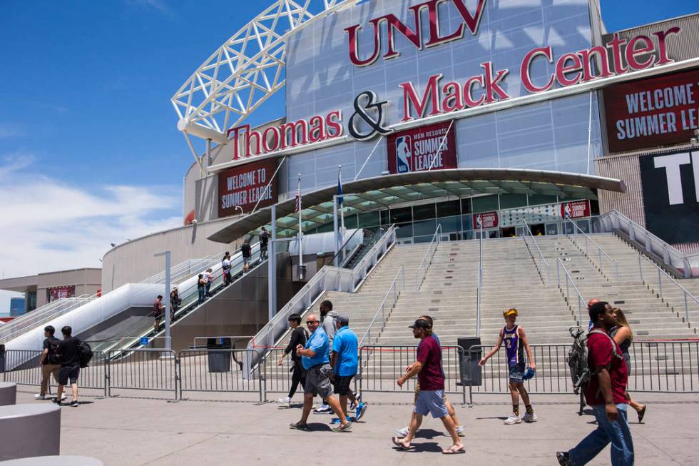 People walk outside of the Thomas & Mack Center on the opening day of Vegas Summer League i ...