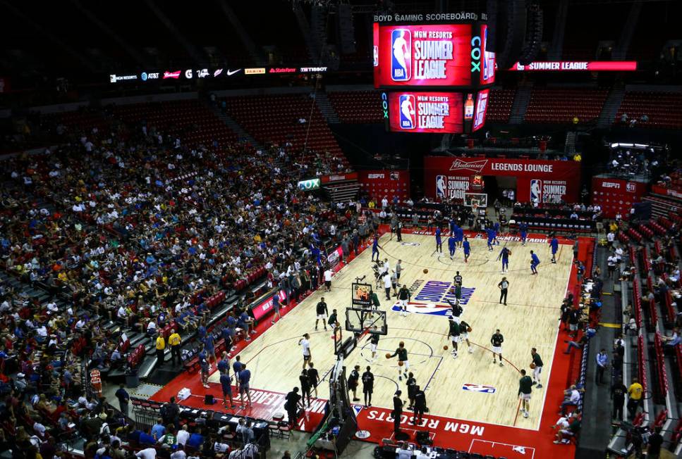 Players for the Milwaukee Bucks and Philadelphia 76ers warm up before the start of a basketball ...